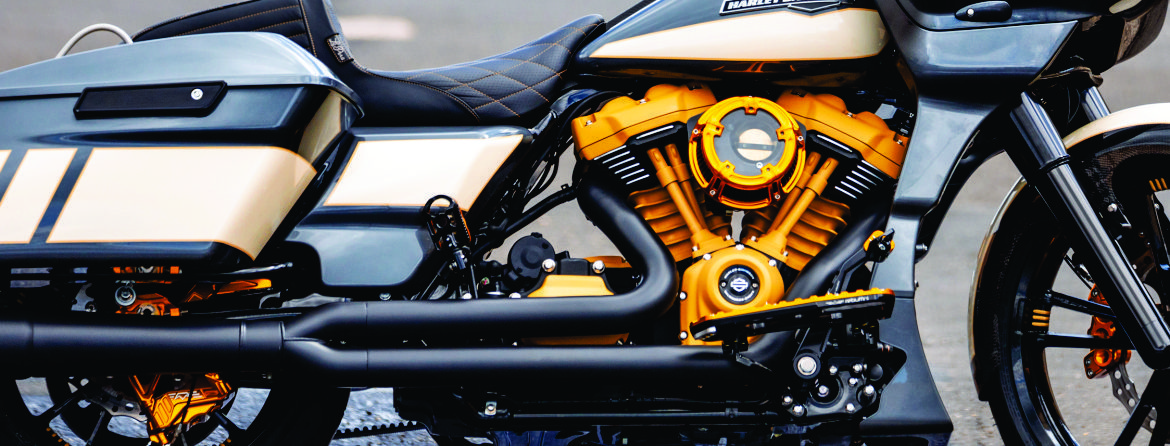 Close-up of a custom motorcycle with a gold engine, photographed by NAMZ